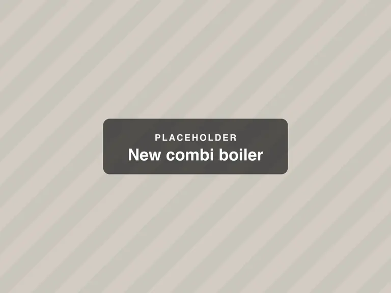 A new combi boiler fitted in a kitchen cupboard